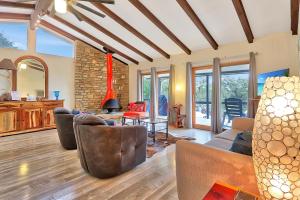 a living room with a couch and chairs and a table at The Summit in Wimberley