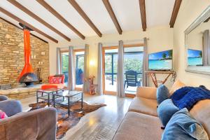 a living room with a couch and a fireplace at The Summit in Wimberley +25 photos