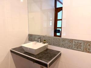 a bathroom with a sink and a mirror at Andina Amazon Lodge in Chachapoyas