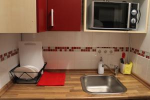 a kitchen with a sink and a microwave at Fair Trade Apartment in Düsseldorf