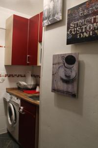 a kitchen with a painting of a coffee cup on the wall at Fair Trade Apartment in Düsseldorf