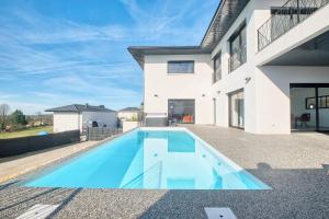 a swimming pool in the backyard of a house at BELLEVUE 1, piscine, jacuzzi, sauna in Champcevinel