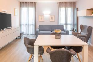 a living room with a table and a couch at Giardinello Apartments in Bardolino