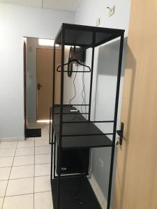 a black shelf in a hallway with a mirror at Pousada Madre De Deus in Brejo da Madre de Deus +1 photo