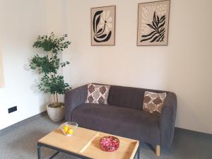 a living room with a couch and a coffee table at Villa Gold Poznań in Poznań