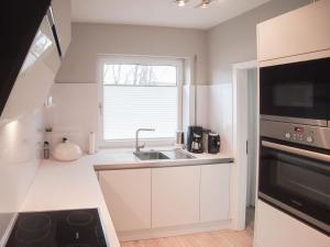 a kitchen with a sink and a window at Weedkroog in Timmendorfer Strand