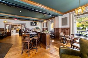 a restaurant with tables and chairs and a bar at The White Inn in Fredonia