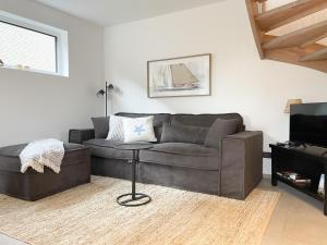 a living room with a couch and a table at Hygge Hus 2 in Timmendorfer Strand