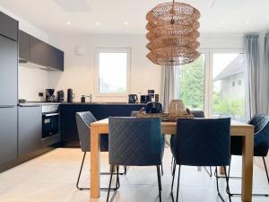 a kitchen and dining room with a table and chairs at Hygge Hus 2 in Timmendorfer Strand +31 photos