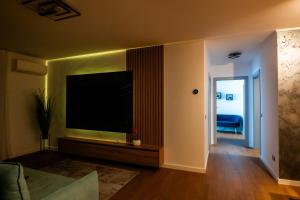 a living room with a large flat screen tv on a wall at Elite Luxury Crib in Cluj-Napoca