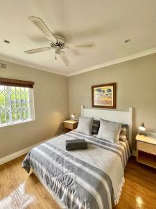 a bedroom with a bed with a ceiling fan at Breede340 - Living the Breede in Malgas