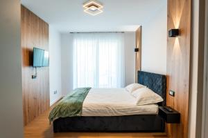 a bedroom with a bed and a window at Elite Luxury Crib in Cluj-Napoca