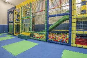 a play room with a bunch of play equipment at APPARTAMENTI LATEMAR con PISCINA e SAUNA in Cavalese