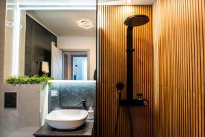 a bathroom with a sink and a glass shower at Elite Luxury Crib in Cluj-Napoca +30 photos