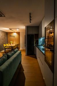 a living room and kitchen with a couch and a table at Elite Luxury Crib in Cluj-Napoca