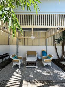 a patio with chairs and a table and a piano at The San Juan House in san juan la union