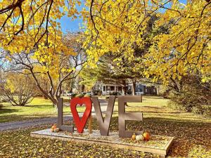 a heart sign in a park with pumpkins on the ground at Roadhaven1830 in Mount Jackson