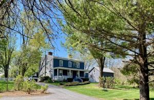 a house with a blue roof and trees at Roadhaven1830 in Mount Jackson
