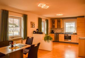 a kitchen with a dining table and a refrigerator at Ferienhaus Wellisch in Lohberg