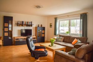 a living room with a couch and a table at Ferienhaus Wellisch in Lohberg