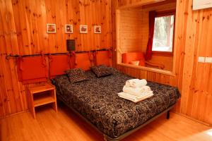 a bedroom with a bed with towels on it at Camping Castillo de Loarre in Loarre