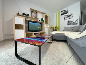 a living room with a couch and a table with a tv at Ferienwohnung Karin in Losheim