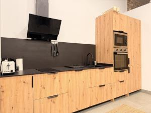a kitchen with a wooden counter with a microwave and a sink at Apartamento Calle Limón in Santander