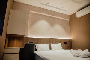 a hotel room with a bed and a large window at Varanashi Inn in Tiruppūr +31 photos