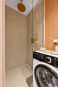 a washing machine in a bathroom with a shower at Marienholm Seaside Studio in Haapsalu +19 photos