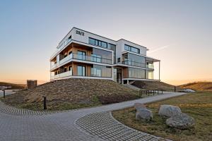 a building on top of a hill with rocks at Marienholm Seaside Studio in Haapsalu