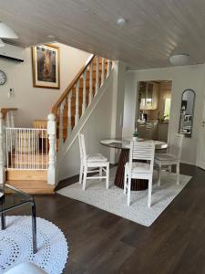 a dining room and kitchen with a table and chairs at Kaliininkuja 1 in Lapua +19 photos