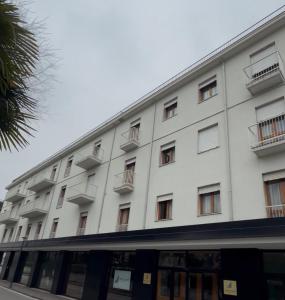 a white building with balconies on the side of it at UNITY BANK HOTEL Termale Padova RC12 in Abano Terme
