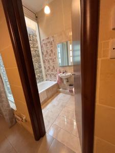 a bathroom with a tub and a sink at Serenity Wellness Farmhouse With Private Sauna in Nadur +18 photos