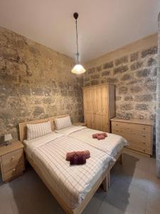 a bedroom with a bed with two pillows on it at Serenity Wellness Farmhouse With Private Sauna in Nadur