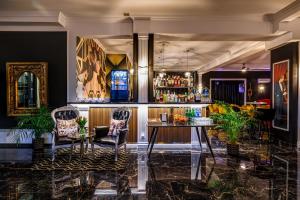 a bar with chairs and a table in a room at Hotel Południk Park Conference&SPA in Stargard +40 photos