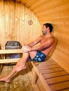 a man is sitting in a sauna at Sel - Hótel Mývatn in Myvatn