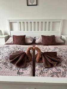 a bed with two towels and two snakes on it at Penzion Šedivý in Strachotín