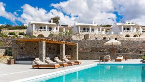 a villa with a swimming pool in front of a building at Double Pool Villa Ι in Kampos Paros