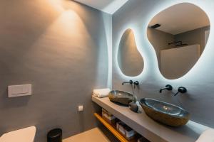 a bathroom with two sinks and a mirror at Double Pool Villa Ι in Kampos Paros +25 photos