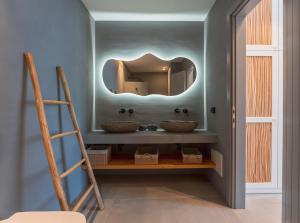 a bathroom with two sinks and a mirror at Double Pool Villa Ι in Kampos Paros