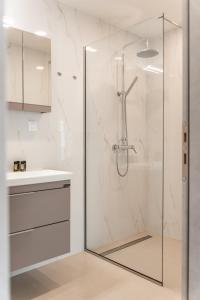 a shower with a glass door in a bathroom at M P A Luxury Apartment Α2 in Agios Nikolaos +64 photos