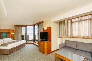 a hotel room with a bed and a couch at The View Hotel in Eastbourne