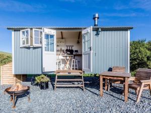 a tiny house with a picnic table and benches at 1 Bed in Boscastle oc-84015 in Boscastle