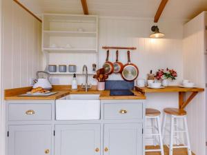 a kitchen with white cabinets and a sink at 1 Bed in Boscastle oc-84015 in Boscastle