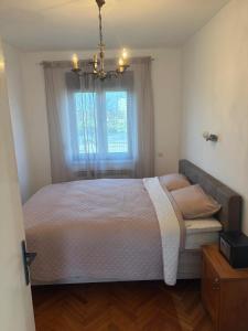 a bedroom with a large bed with a window at Magnolia guest house in Karlovac