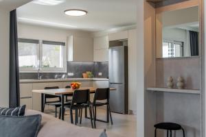 a kitchen and dining room with a table and chairs at M P A Luxury Apartment Α2 in Agios Nikolaos