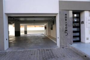 an empty hallway of a building with a parking lot at Le vert Emeraude in Sfax +2 photos