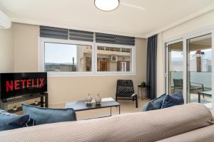 a bedroom with a bed and a living room at M P A Luxury Apartment Α2 in Agios Nikolaos