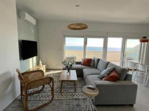 a living room with a couch and a table at Penthouse SKY DELUXE in Novalja