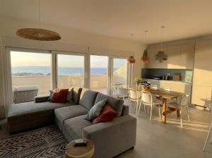 a living room with a couch and a table at Penthouse SKY DELUXE in Novalja